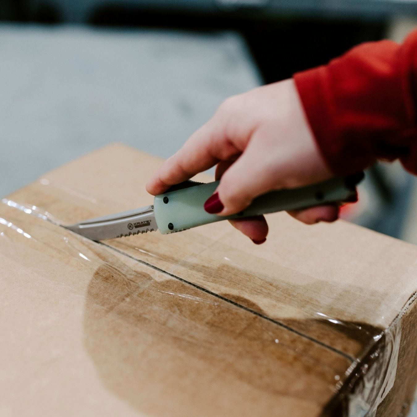 barracuda otf knife cutting open a package