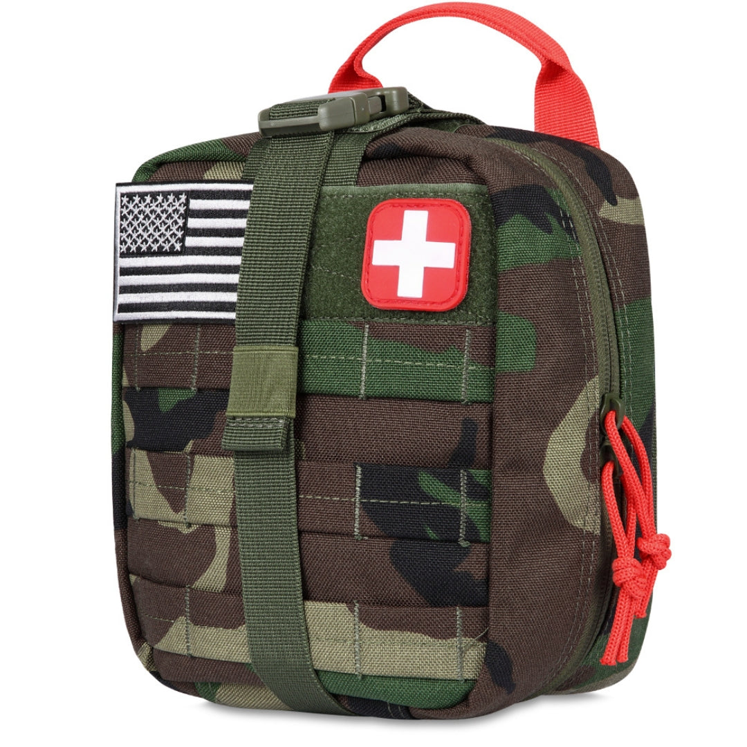 Camouflage medical trauma kit with American flag and red cross patch on a white background