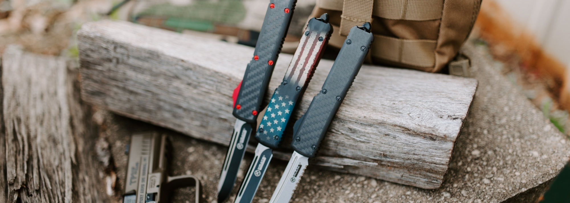 three krate tactical knives on a wooden block