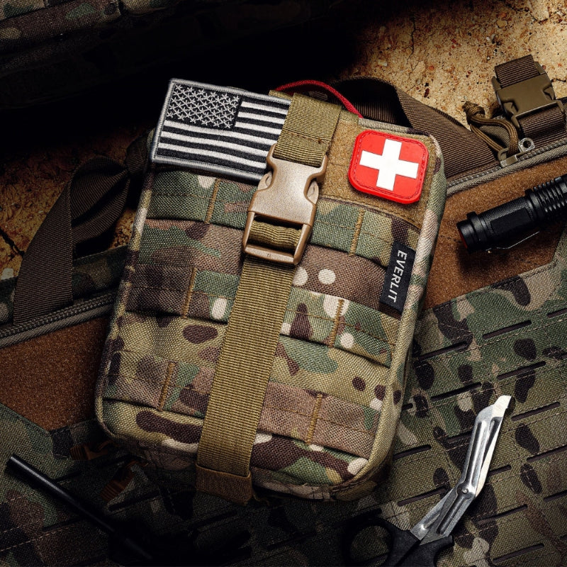 Camouflage tactical pouch with American flag patch and first aid kit symbol on a camouflage background.