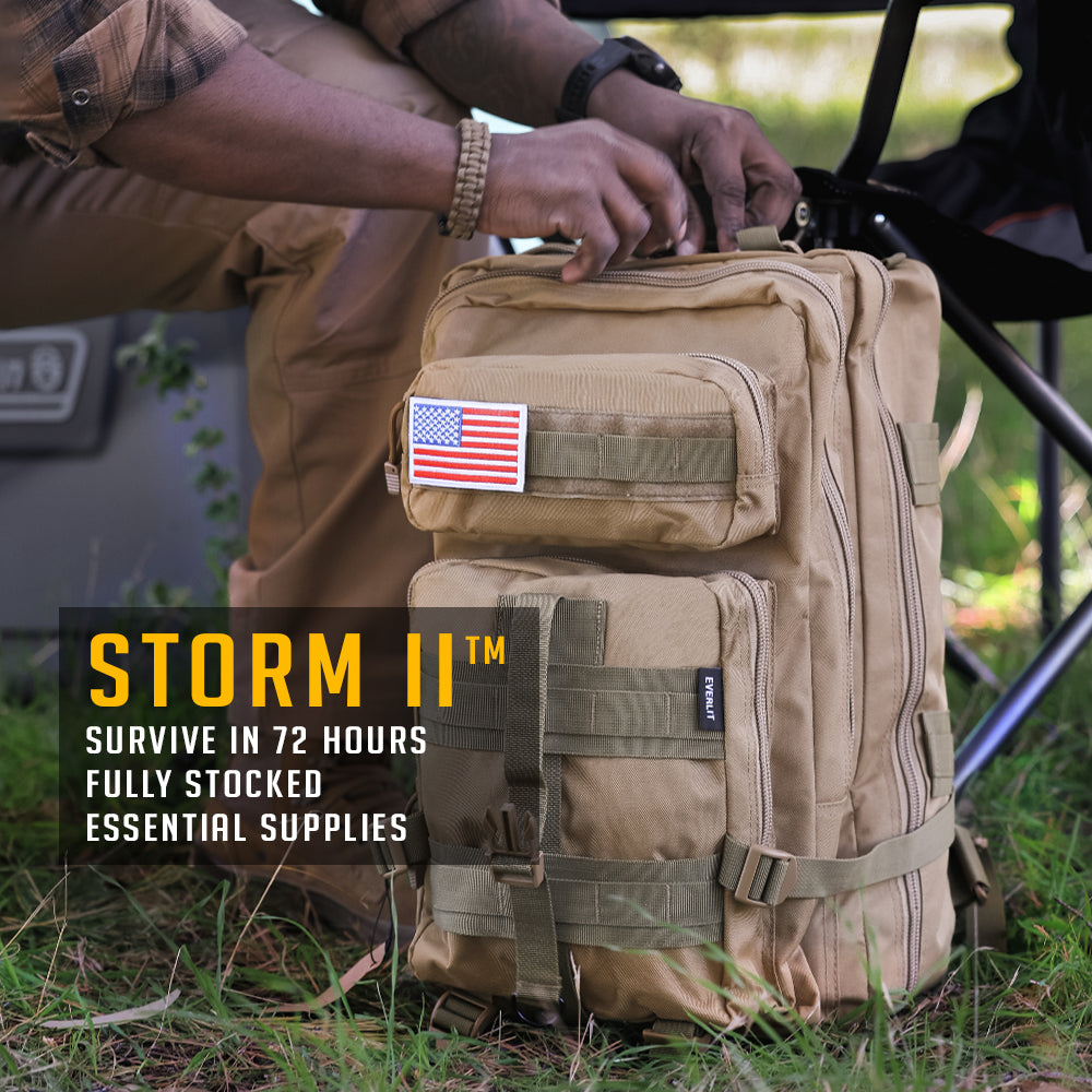 Tactical backpack with American flag patch, labeled 'STORM II', on a grassy background.