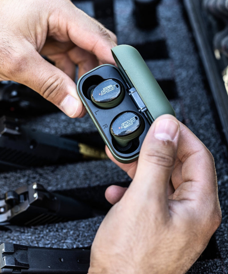 hands holding a case of ear protectors 