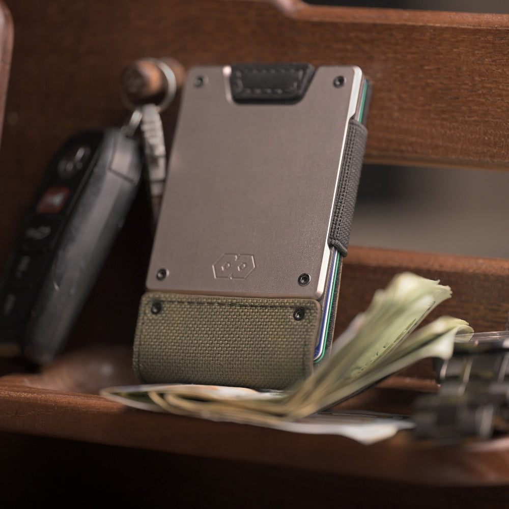 olive green proof wallet on nightstand with car keys