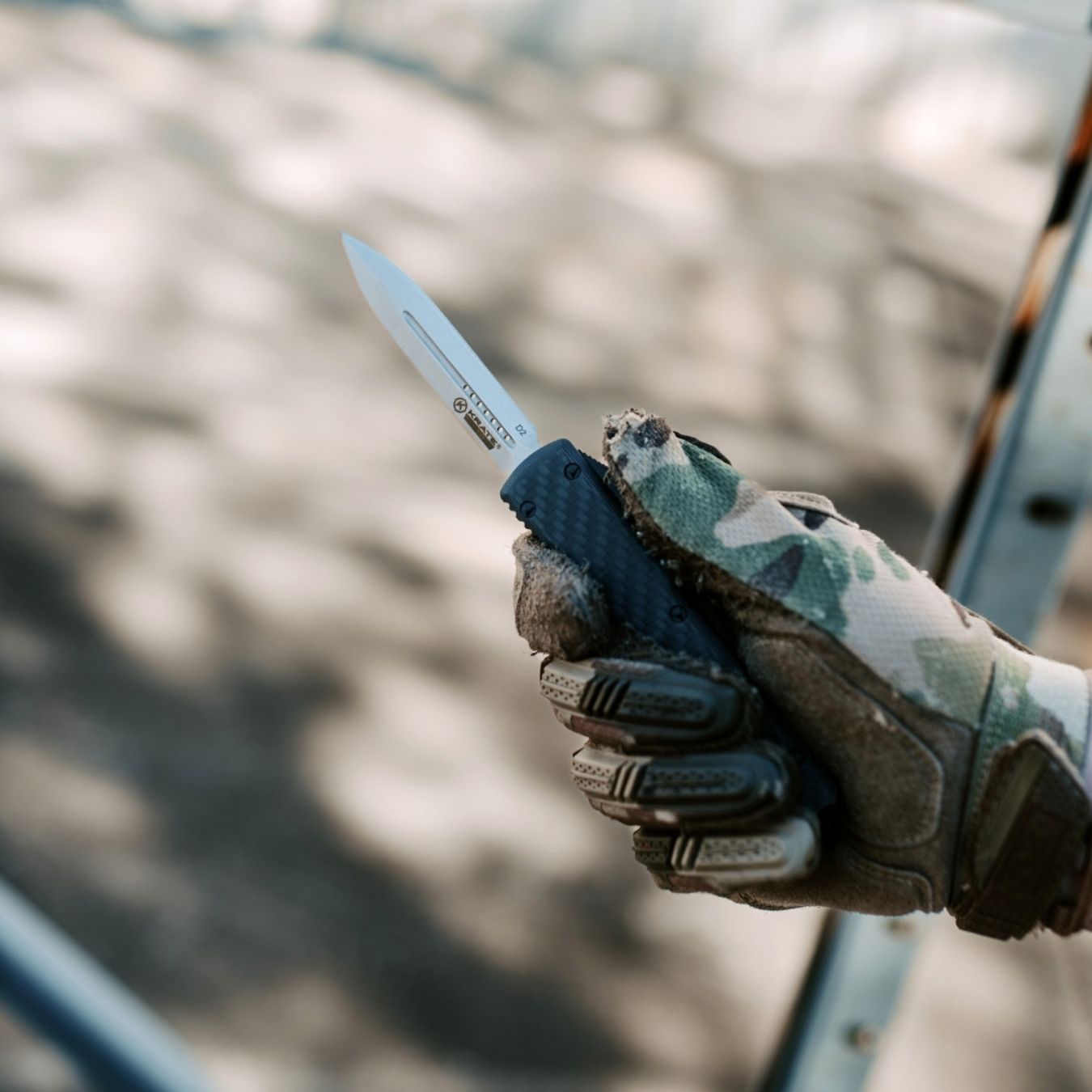 parallax otf knife with double edge blade being used outside